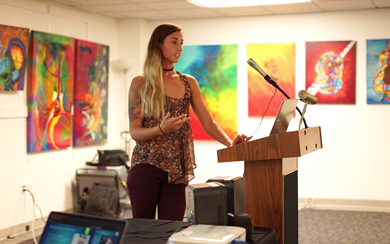 Ethical Elizabeth speaking at a podium